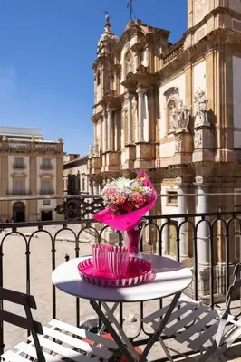a table with a vase of flowers on top of a building at Vista San Domenico in Palermo