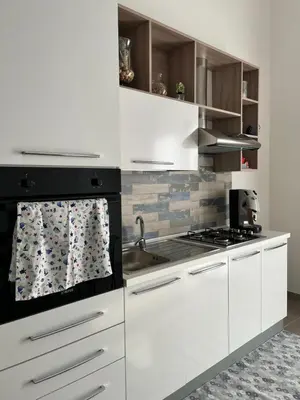 a kitchen with white cabinets and a stove at Azzurra in Terrasini