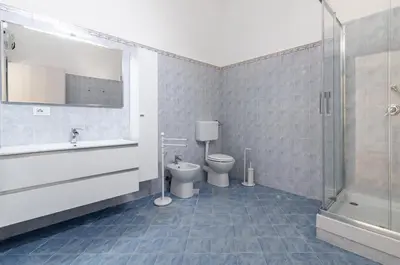 a bathroom with a toilet and a sink and a shower at GuestHost - La Dimora dei Mille - Roomy Apartment with Terrace in Palermo