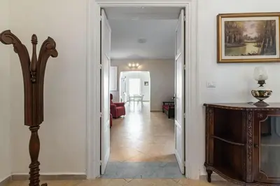 a hallway with a door leading to a living room at GuestHost - La Dimora dei Mille - Roomy Apartment with Terrace in Palermo