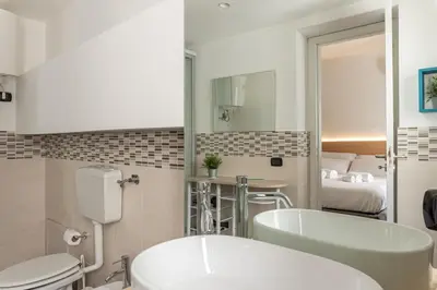 a bathroom with a tub and a toilet and a sink at Naos Home - Alle Spalle del Teatro Massimo in Palermo