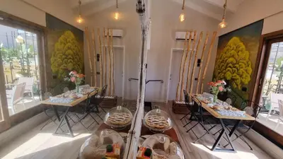 a dining room with two tables with food on them at LE TRE NINFE Cinisi in Cinisi