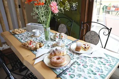 a table with plates of pastries on it at LE TRE NINFE Cinisi in Cinisi