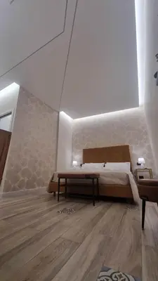 a bedroom with a bed and a wooden floor at LE TRE NINFE Cinisi in Cinisi