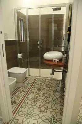 a bathroom with a shower and a toilet and a sink at LE TRE NINFE Cinisi in Cinisi