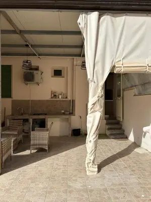 a living room with a table and a white curtain at La casa di Gabri in Palermo