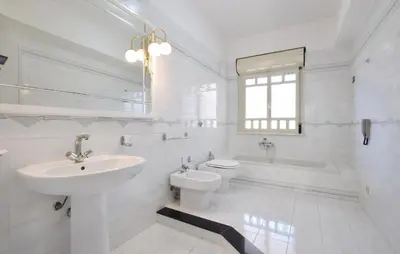 a white bathroom with a sink and a toilet and a tub at Lovely Apartment In Casteldaccia in Casteldaccia