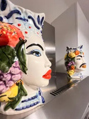 a ceramic statue of a woman and a statue of a man at Le Case di Ciccine' in Bagheria
