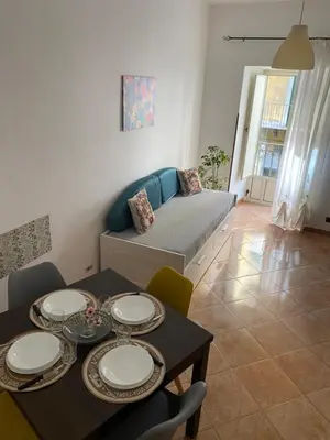 a living room with a table and a couch at La Casetta sul Corso in Palermo