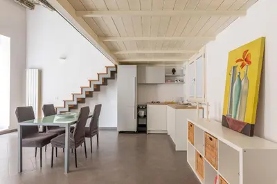 a kitchen and dining room with a table and chairs at MetaM Apartment in the City Center by Wonderful Italy in Palermo