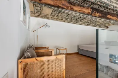 a bedroom with a bed and a wooden floor at MetaM Apartment in the City Center by Wonderful Italy in Palermo
