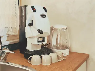 a white mixer sitting on a counter next to cups at Casa Vacanze Imera House in Palermo
