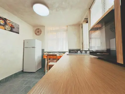 a kitchen with a white refrigerator and a table at Casa Vacanze Imera House in Palermo