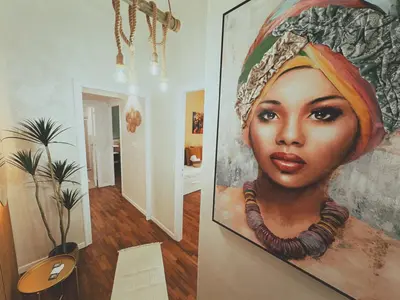 a painting of a woman is hanging on a wall at Casa Vacanze Imera House in Palermo