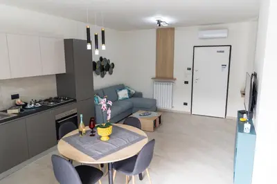 a kitchen and a living room with a table and chairs at Bagheria Home in Bagheria