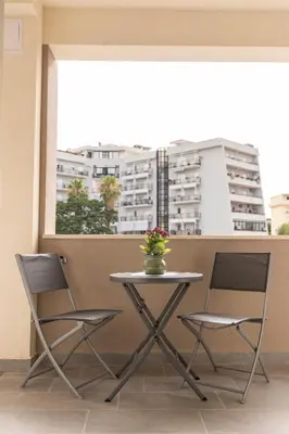 a table and two chairs in a room with a window at Bagheria Home in Bagheria
