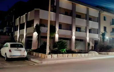 a white car parked in front of a building at Bagheria Home in Bagheria