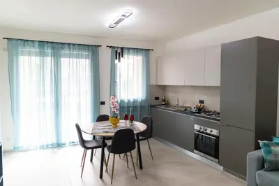 a kitchen and dining room with a table and chairs at Bagheria Home in Bagheria