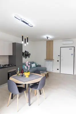 a kitchen and a living room with a table and chairs at Bagheria Home in Bagheria