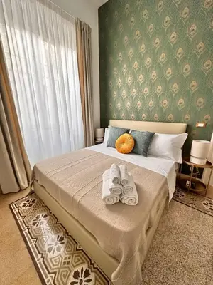 a bedroom with a bed with towels on it at Il Sipario Luxury Apartments in Palermo