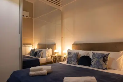 a bedroom with two beds and a large mirror at Il Sipario Luxury Apartments in Palermo