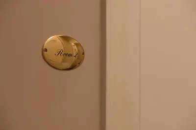 a gold door knob on a door with the word run on it at Il Sipario Luxury Apartments in Palermo