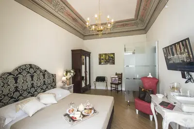 a living room with a bed and a table and a sink at Pane Amore e Marmellata in Palermo