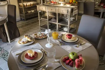 a table with plates of food and fruit on it at Pane Amore e Marmellata in Palermo