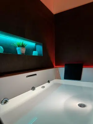 a white bath tub with a tv on the wall at AQUAROOMS Suites in Palermo