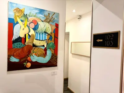 a painting hanging on a wall in a museum at AQUAROOMS Suites in Palermo