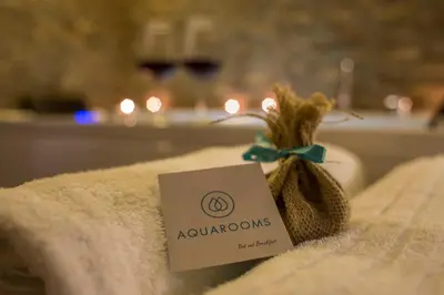 a sign sitting on top of a towel with a bag of onions at AQUAROOMS Suites in Palermo