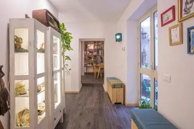 a living room with a hallway with a room with at AQUAROOMS Suites in Palermo