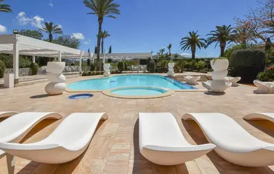 a pool with white lounge chairs and a swimming pool at Cozy Home In Partinico With Wifi in Partinico