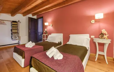 two beds in a room with red walls at Cozy Home In Partinico With Wifi in Partinico