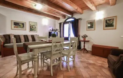 a living room with a table and chairs and a couch at Cozy Home In Partinico With Wifi in Partinico