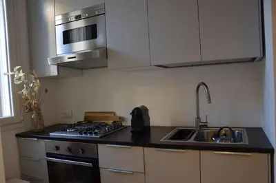 a kitchen with a sink and a stove top oven at Little Loft 39 in Palermo