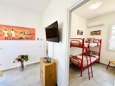 a room with a red bunk bed and a tv at Stella Marina in Carini