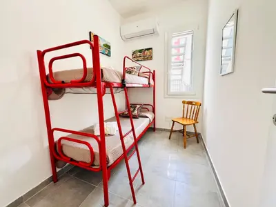 a room with two bunk beds and a chair at Stella Marina in Carini