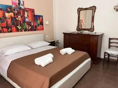 a bedroom with a bed with two towels on it at Home Sweet Home in Palermo
