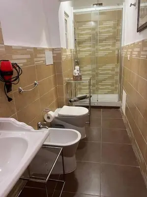 a bathroom with a toilet and a sink and a shower at Home Sweet Home in Palermo