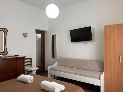 a living room with a couch and a tv on the wall at Home Sweet Home in Palermo