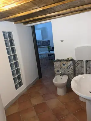 a bathroom with a toilet and a sink at Central Station in Palermo