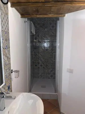 a bathroom with a shower and a white sink at Central Station in Palermo