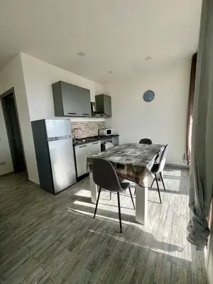 a kitchen with a table and chairs in a room at Mari Sol in Terrasini