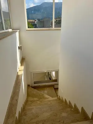 an empty room with a staircase with a window at Mari Sol in Terrasini