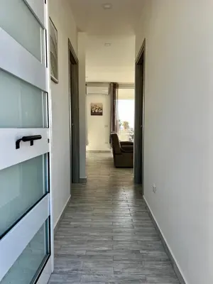 a hallway with a room with a couch at Mari Sol in Terrasini