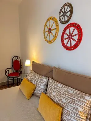 a bedroom with a couch and plates on the wall at Ai Pupi Siciliani in Palermo