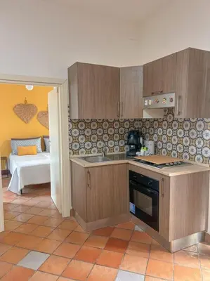 a kitchen with a sink and a stove top oven at Ai Pupi Siciliani in Palermo