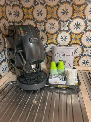 a black mixer sitting on top of a shelf at Ai Pupi Siciliani in Palermo