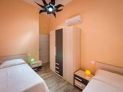 a bedroom with two beds and a ceiling fan at Villa Mari e Monti by Interhome in Castellammare del Golfo